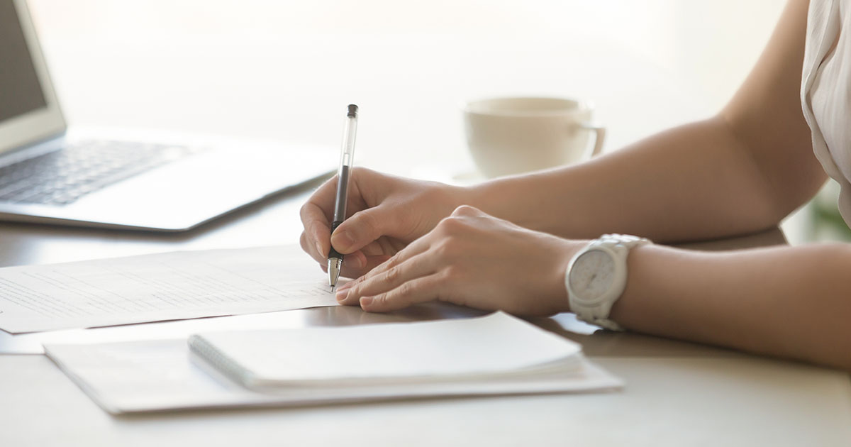 A woman doing paperwork at a desk.