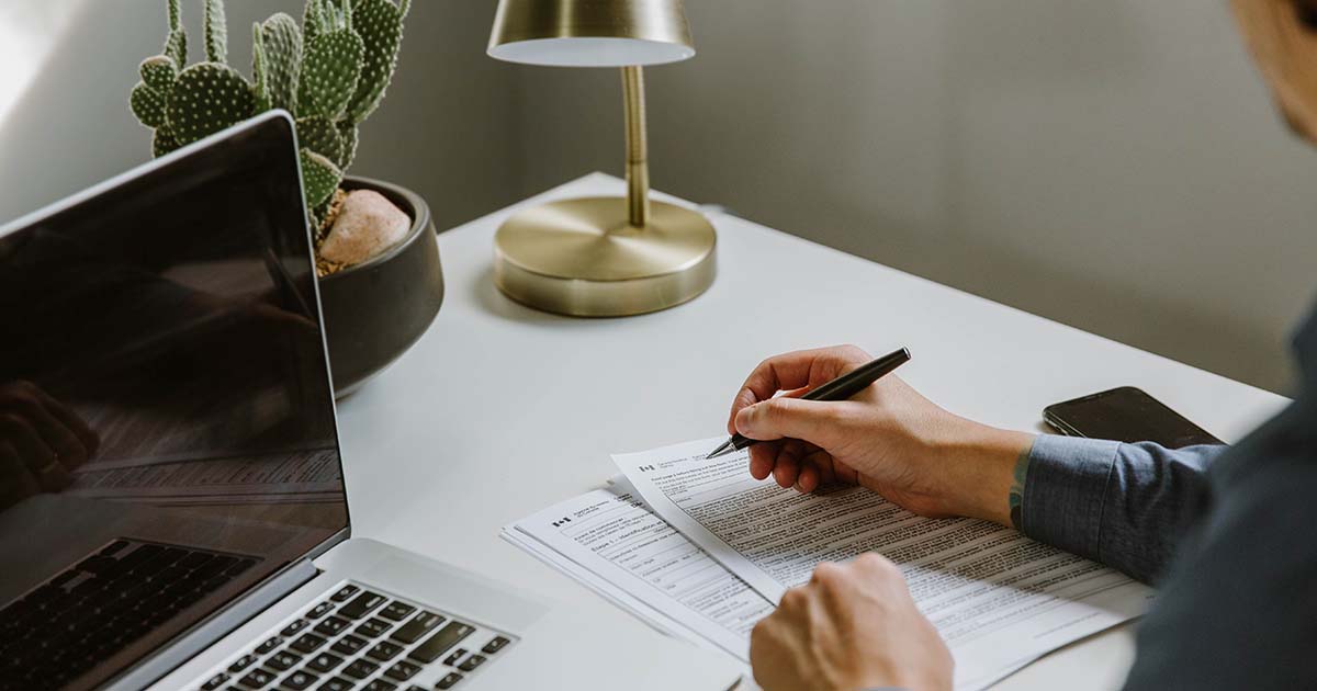 A person doing paperwork at their desk.