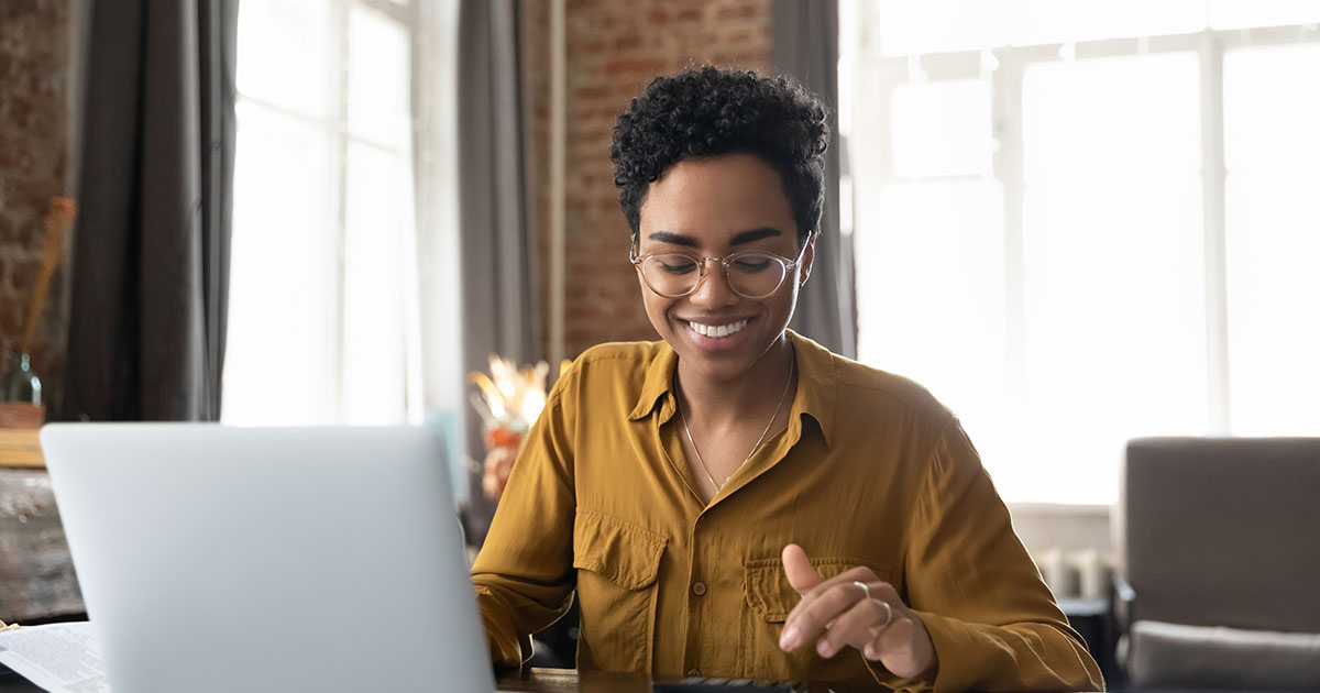 A woman working on a laptop.