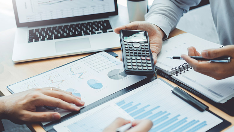 A business team working with financial charts.