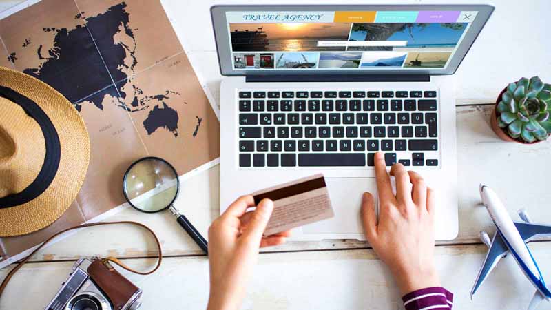 A person booking a vacation on their computer.
