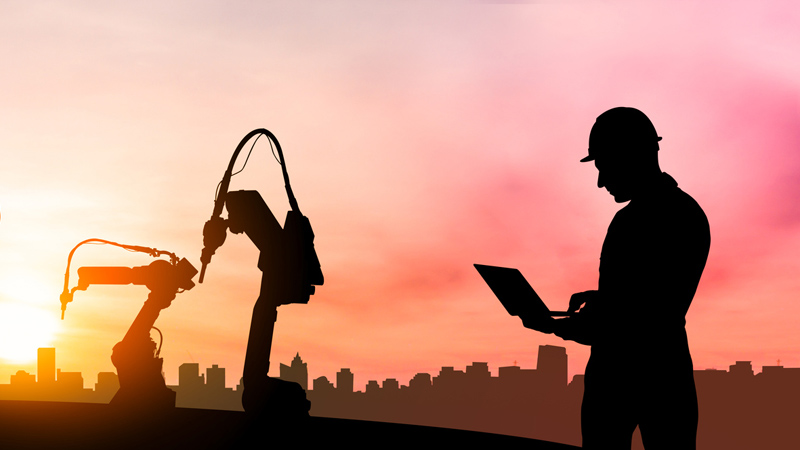 Engineer checking robotic arms.