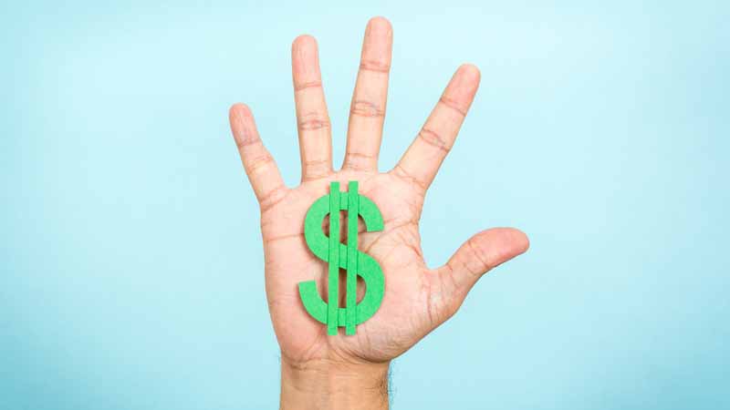 Outstretched hand holding up a green dollar sign.