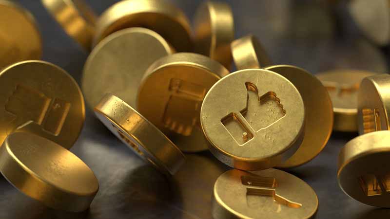 Gold coins with social media like icons.