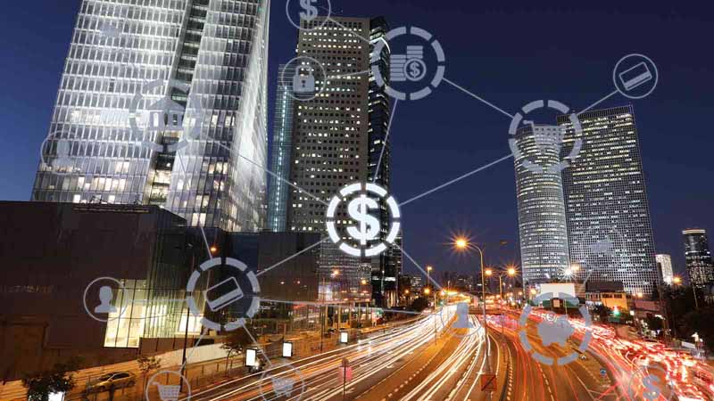 City at night with finance graphic overlays.