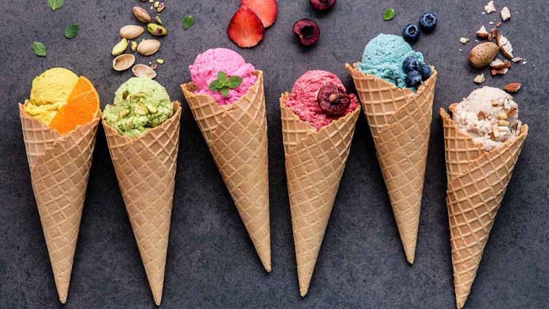 A row of different-flavored ice cream cones.