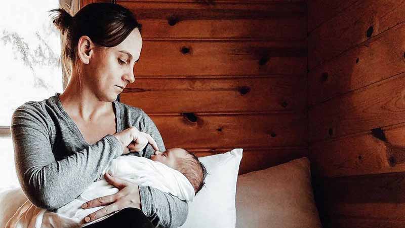 A woman holding a baby.