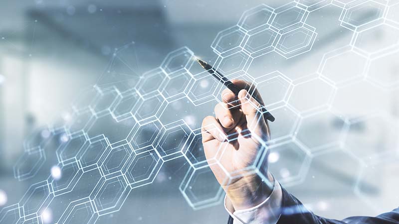 Person using pen to draw virtual hexagon pattern.