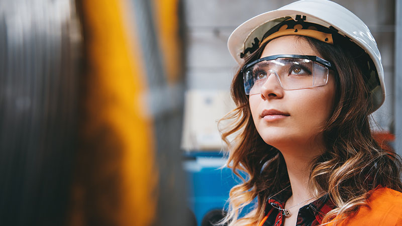 An engineer wearing safety gear in a warehouse.