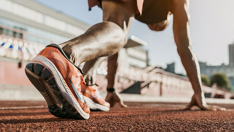Closeup of an athlete getting ready to run.
