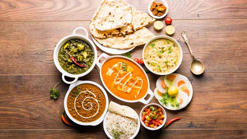 Assorted plates of South Asian food.