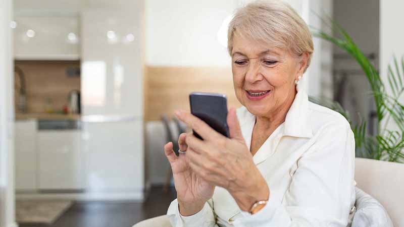 An older woman using a smartphone.