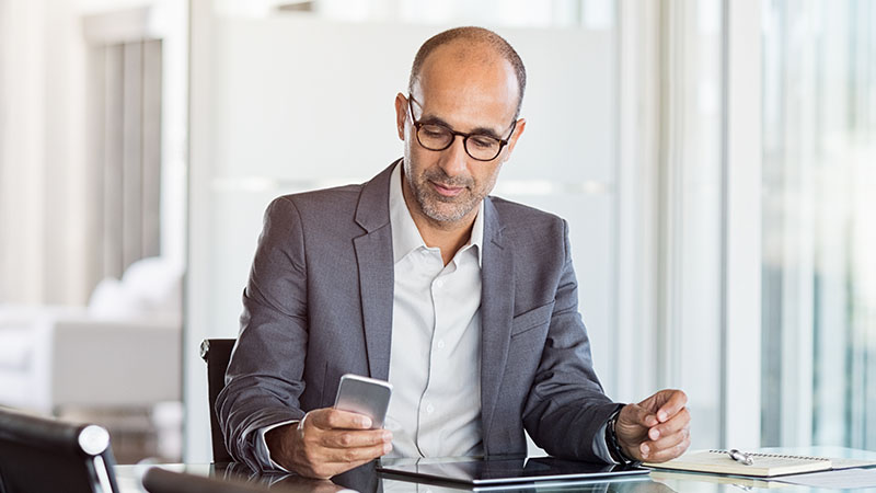 Businessman working on a phone.