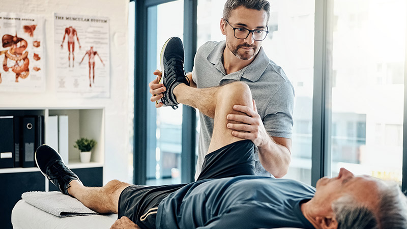 A physiotherapist helping a patient.