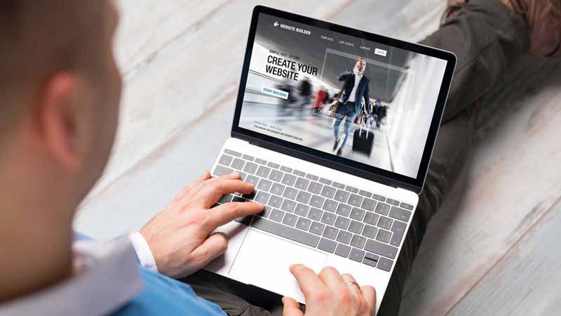 A man creating a business website on his laptop.