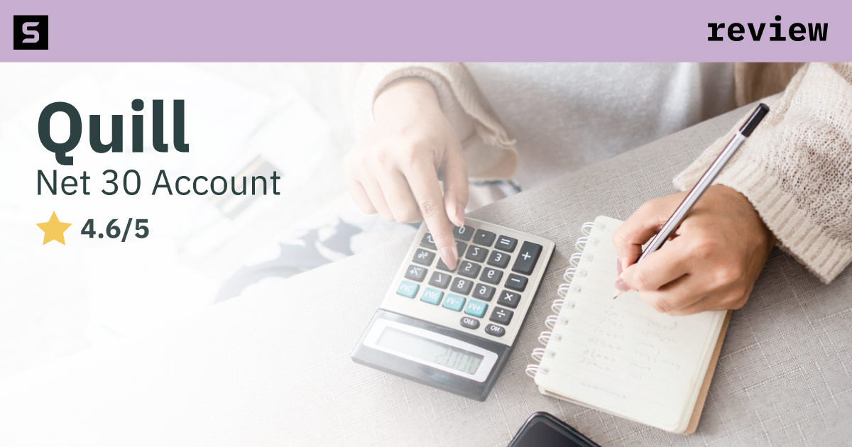 Woman writing in notebook and using a calculator.
