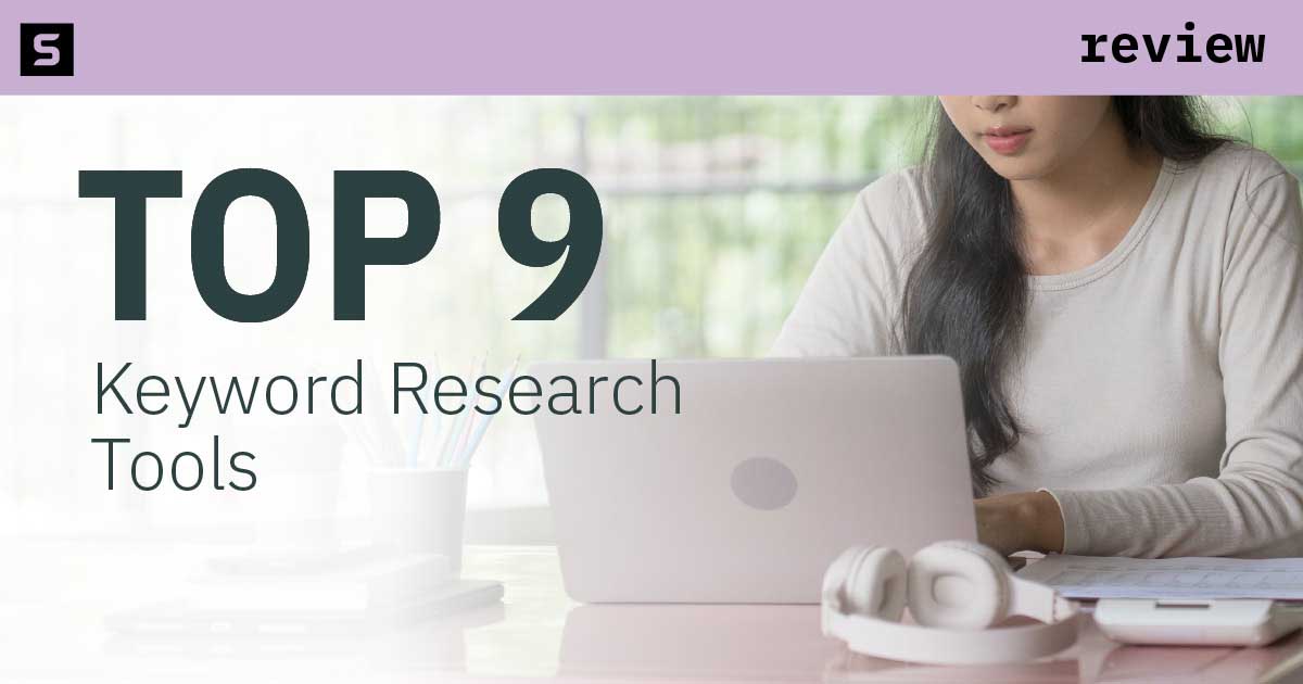 Woman typing and looking at the top keyword research tools.