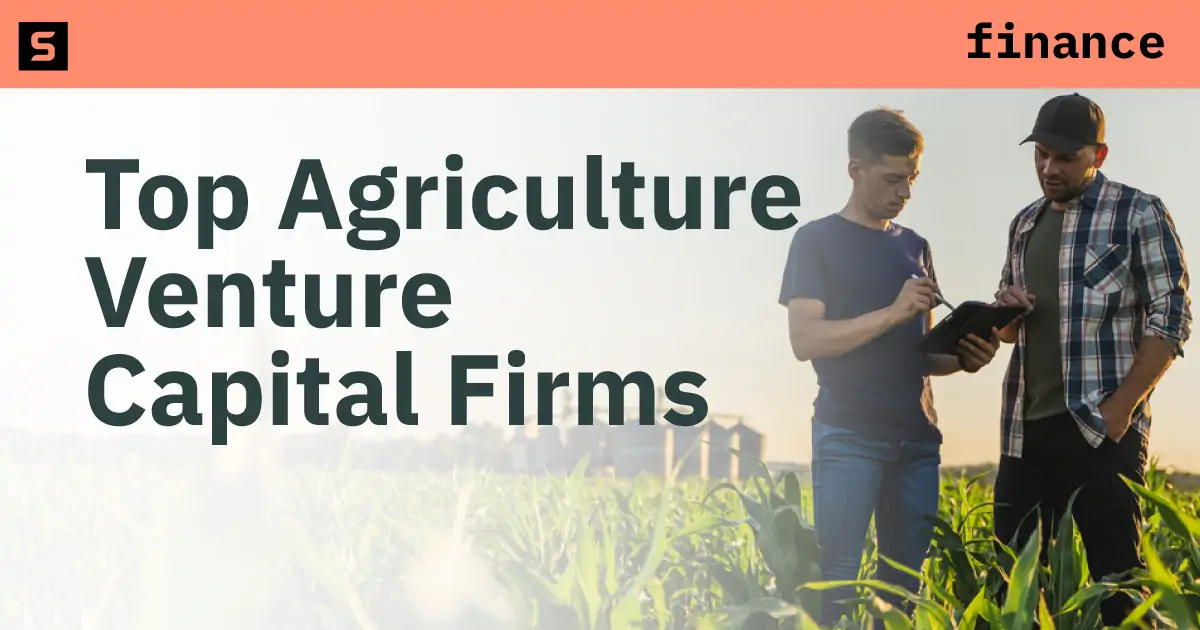 Two men talking in a farm field.