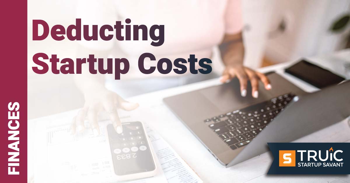 Person working on a computer with a calculator.