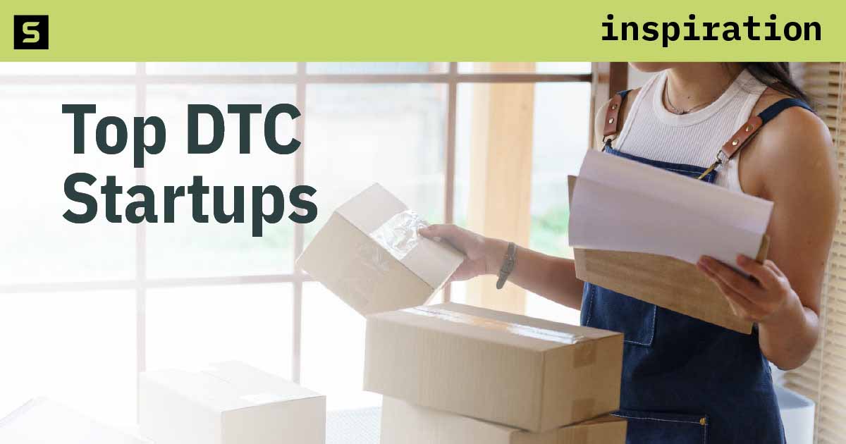 Two people looking at a laptop in an office.