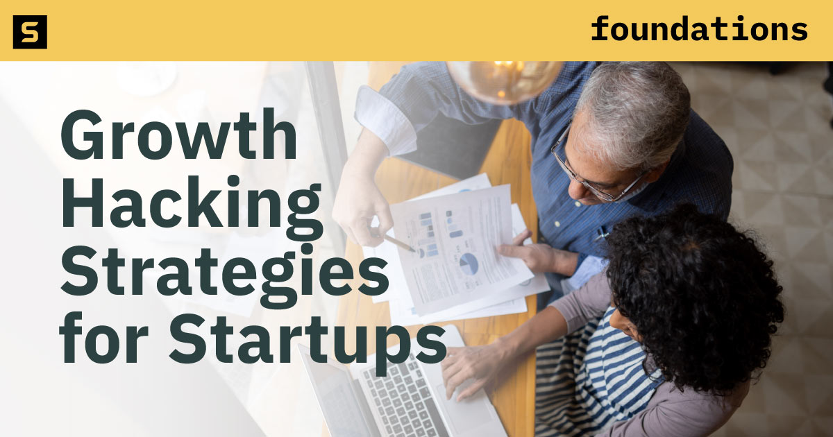 Man and woman analyzing marketing charts.