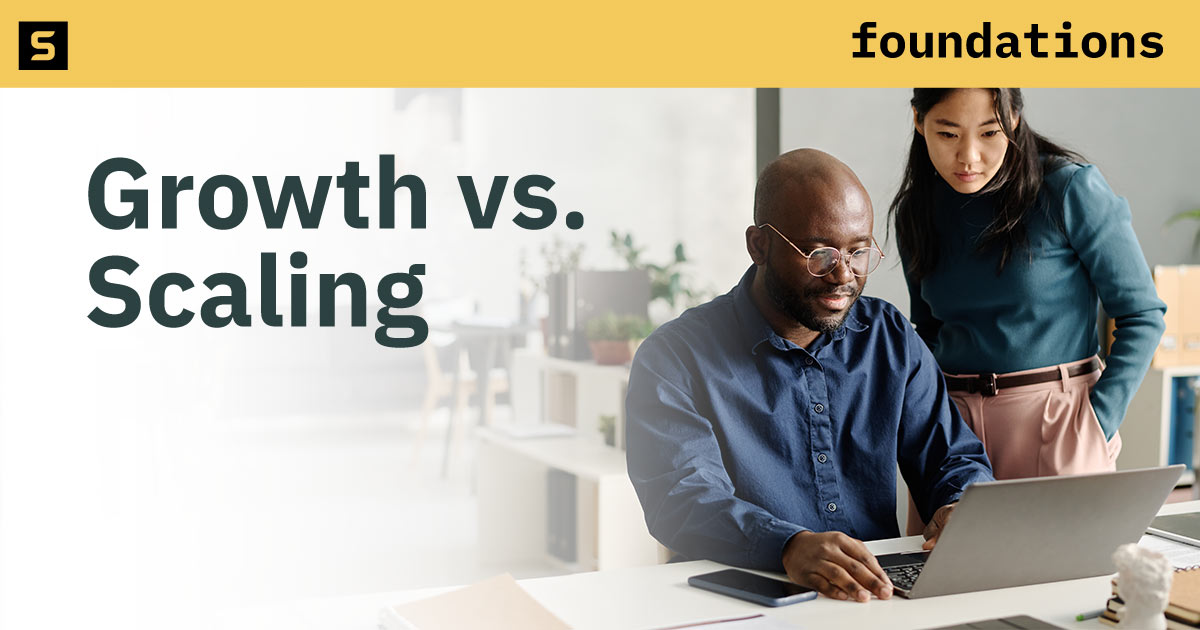 Coworkers working at a computer together.