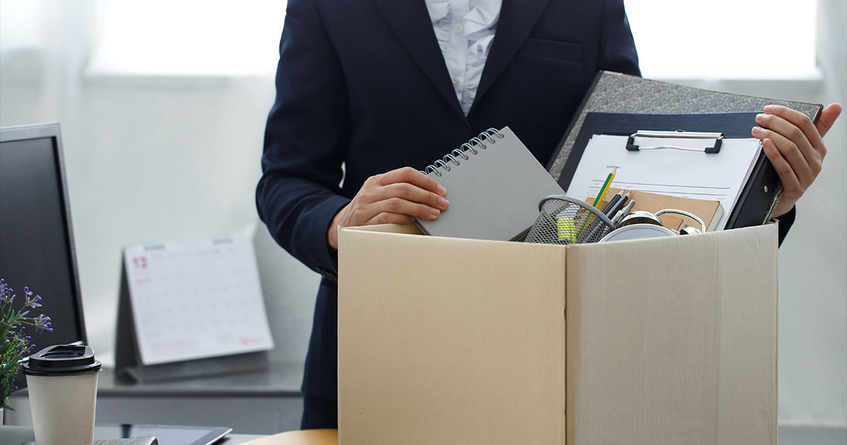 Business woman packing up belongings.