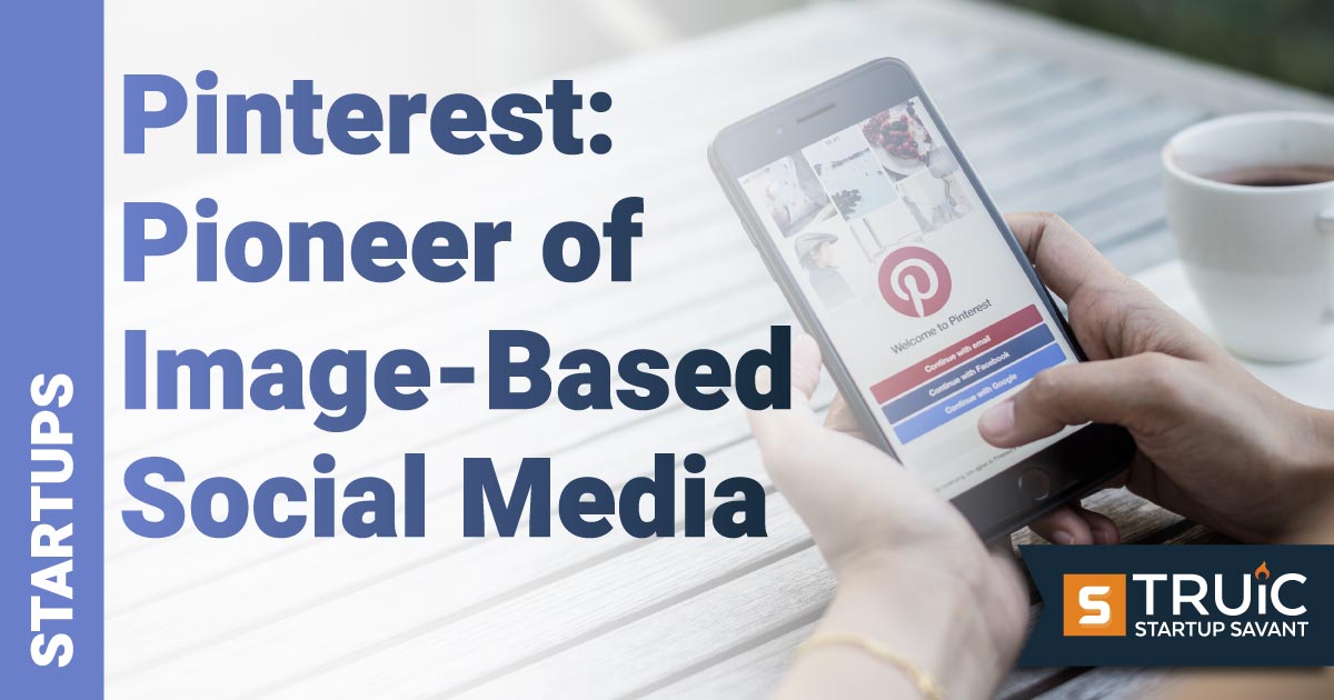 Hand holding phone with Pinterest app open.