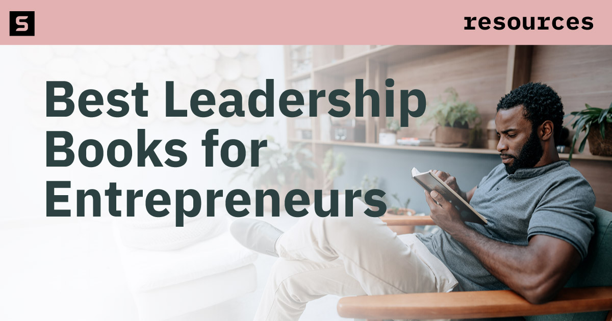 Man in a suit reading a book.