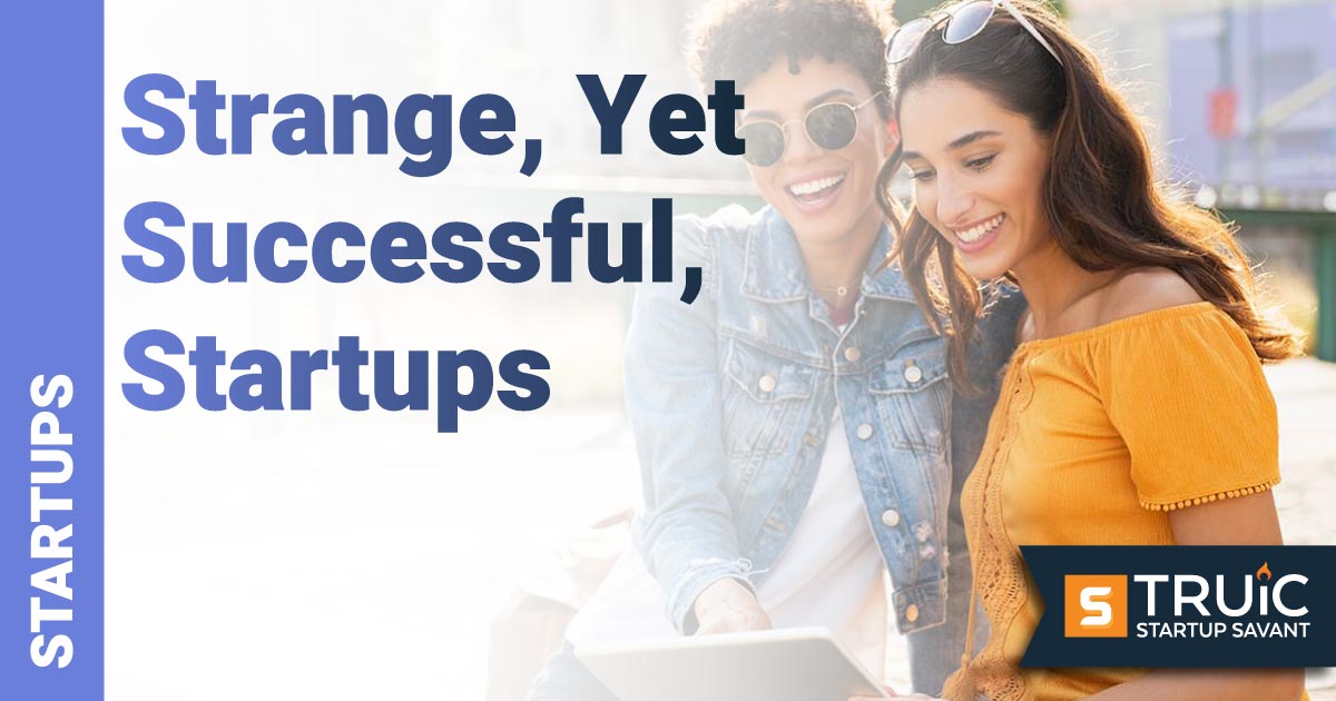 Two women using tablet outside.