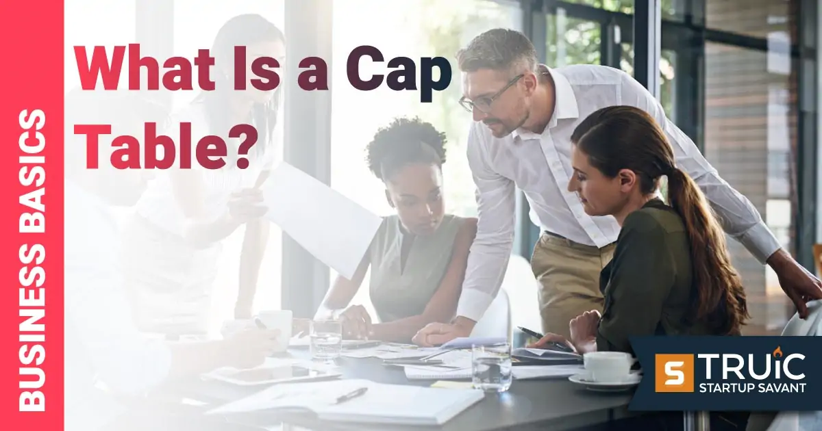 Group of people looking at a cap table in an office.