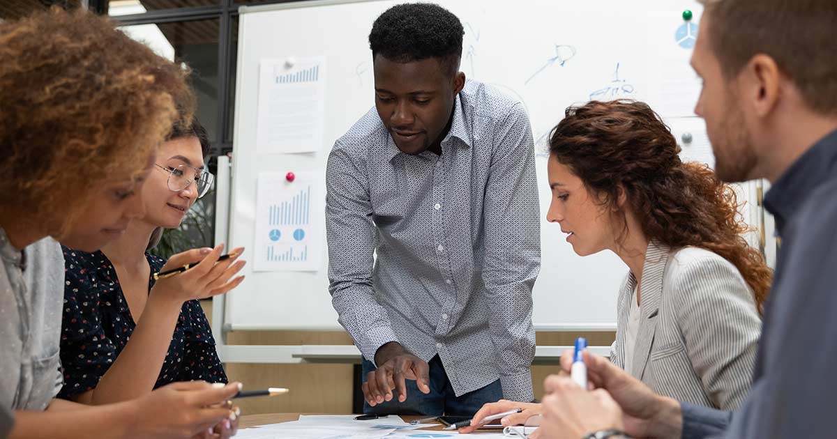 People at a table in a meeting.