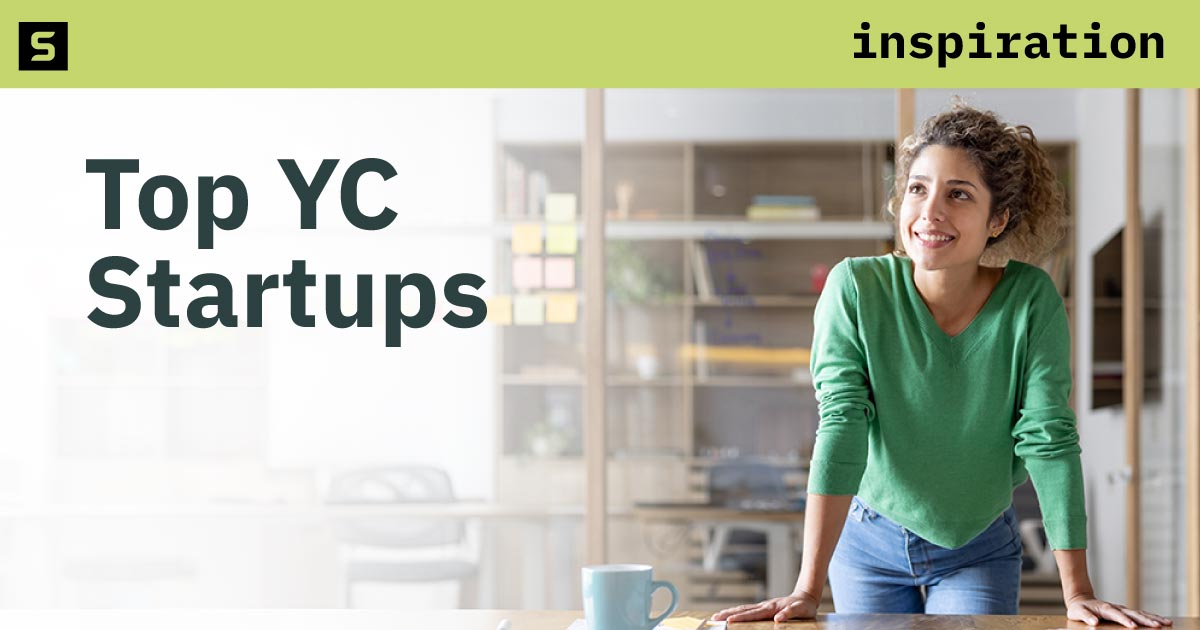 A group of people looking at a laptop in an office.