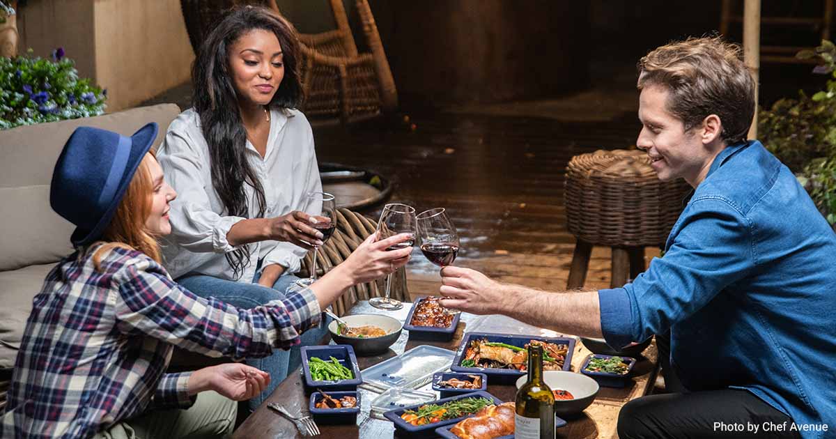 Group of friends enjoying wine and food.