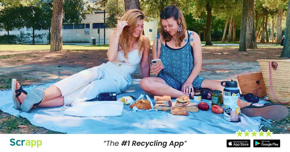 Scrapp graphic with two women during a picnic on a phone, with text saying, Scrapp, the #1 recycling app.