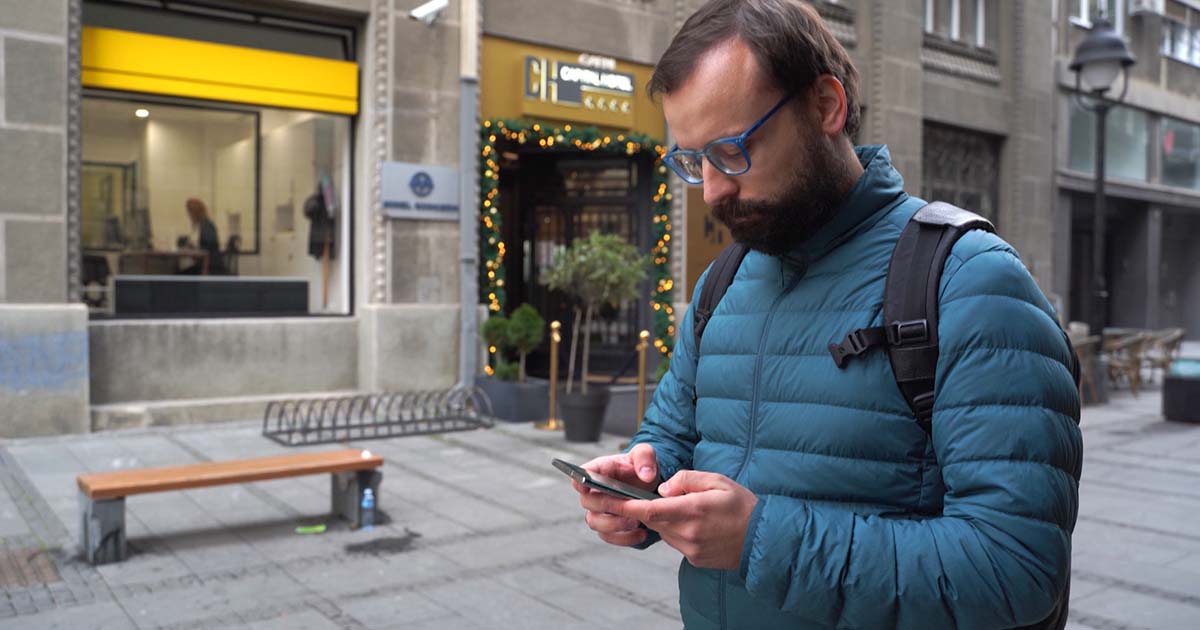 Bitebell founder walking outside while on his phone