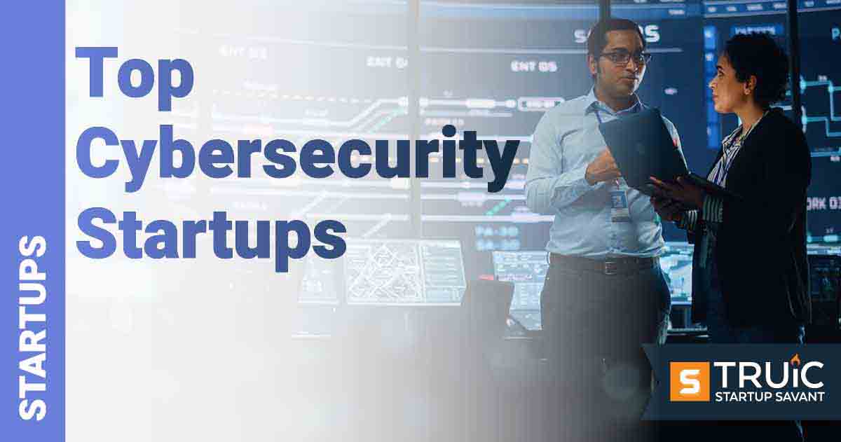 Two people discussing in front of a computer monitor.