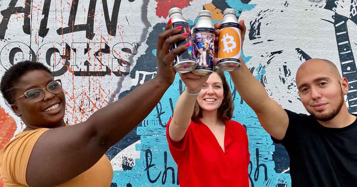 A group of people holding FreeWater bottles.