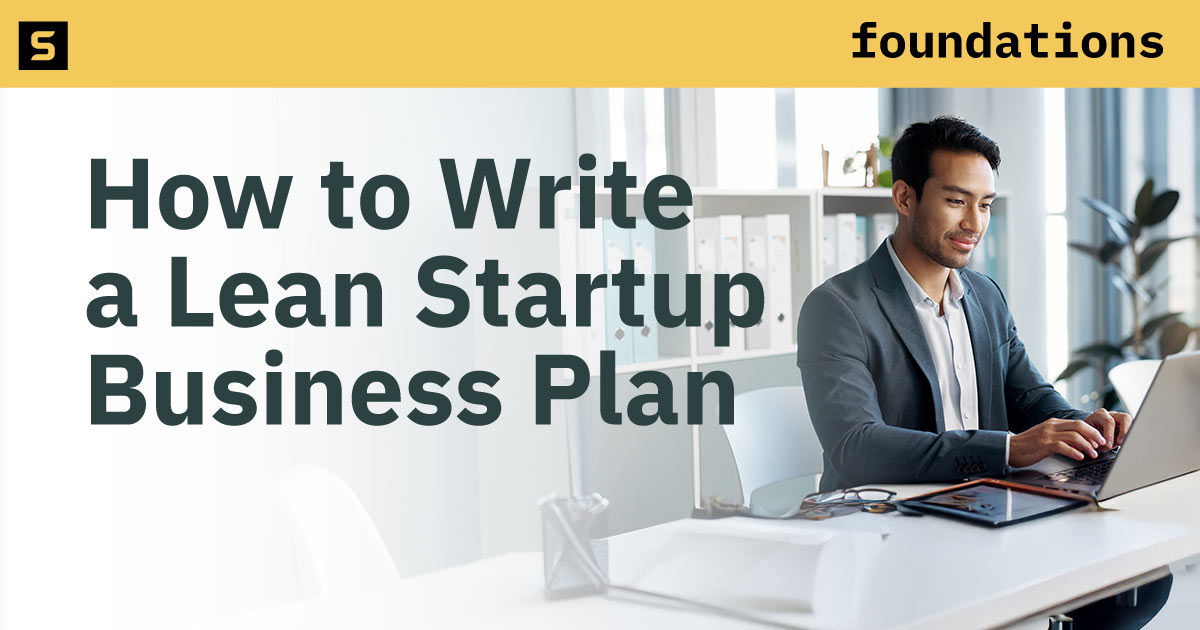 Businesswoman writing notes at her computer.