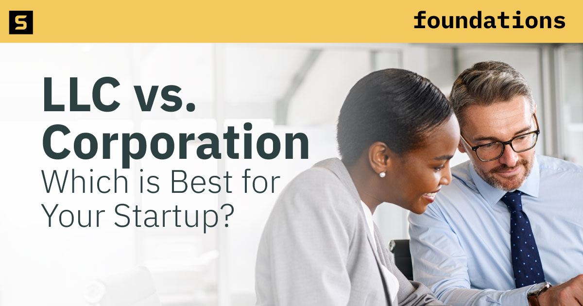 Businessman holding a document and using his laptop.