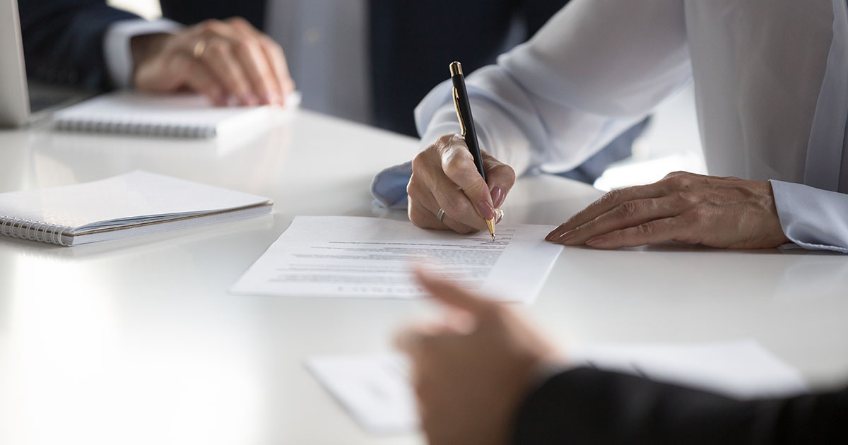 Businesswoman signing document.