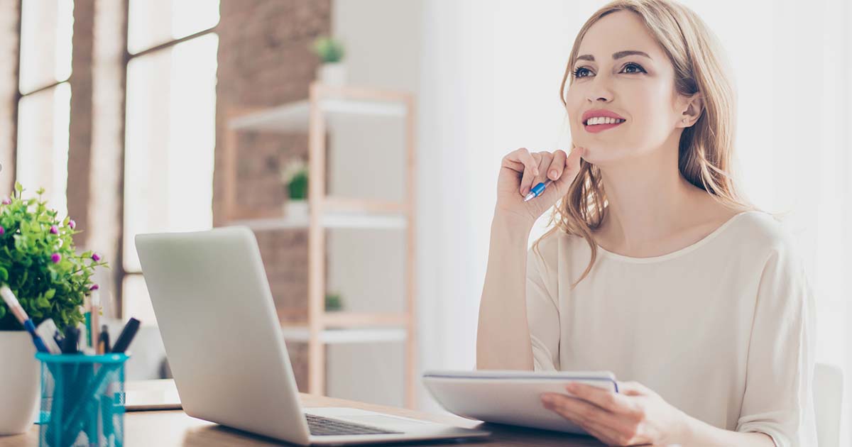 Woman writing in a journal.