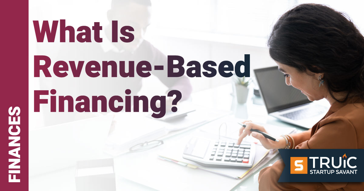 Woman at desk with calculator going over business finances.