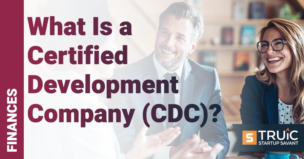 People at a table discussing a certified development company.
