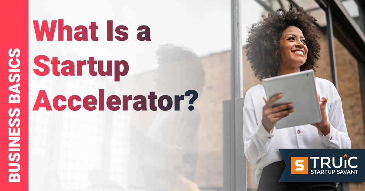 Young woman smiling and posing while working with colleagues.